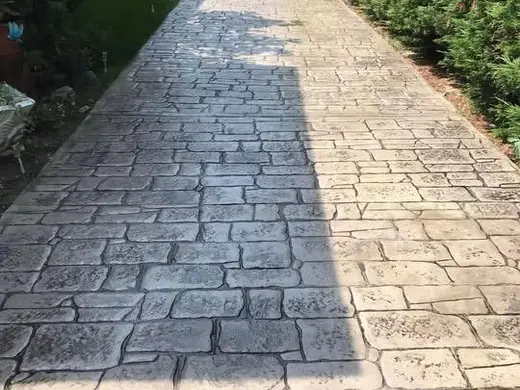 Stamped concrete in an antique cobble pattern with small rough stones, photo 9