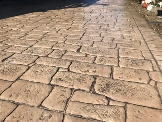 Stamped concrete in an antique cobble pattern with small rough stones, photo 19