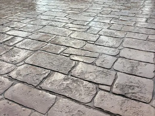 Stamped concrete in an antique cobble pattern with small rough stones, photo 21