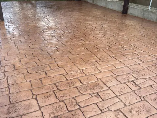 Stamped concrete in a tile pattern with pitted texture, photo 1