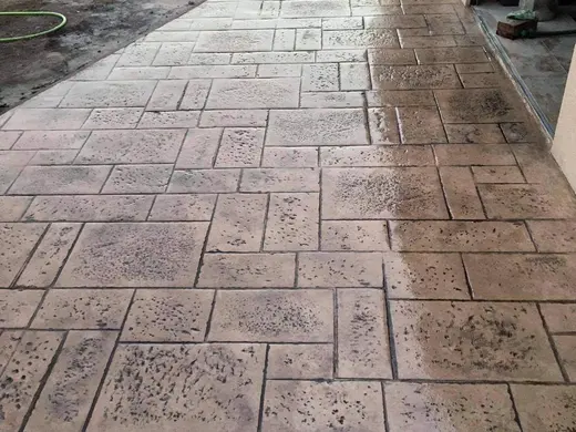 Stamped concrete in a tile pattern with pitted texture, photo 2