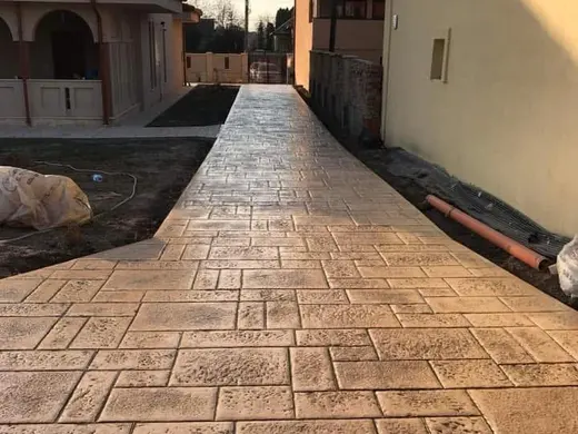 Stamped concrete in a tile pattern with pitted texture, photo 17