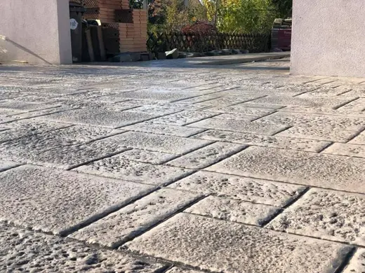 Stamped concrete in a tile pattern with pitted texture, photo 26